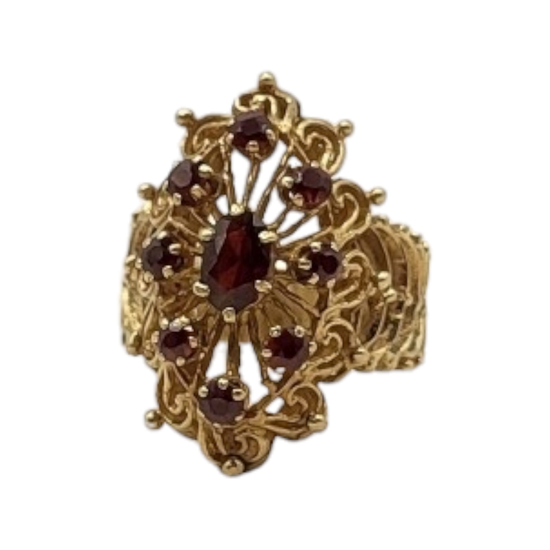 A VINTAGE YELLOW METAL AND GARNET CLUSTER RING Having an oval cut central stone edged with round cut - Image 2 of 3