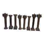 A SET OF EIGHT 19TH CENTURY CARVED PROVINCIAL OAK CORINTHIAN COLUMNS With ebonised patination. (42.
