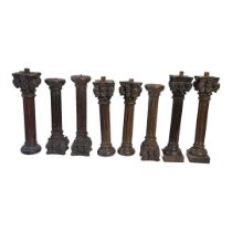 A SET OF EIGHT 19TH CENTURY CARVED PROVINCIAL OAK CORINTHIAN COLUMNS With ebonised patination. (42.