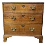 AN EARLY VICTORIAN SOLID OAK CHEST Having an arrangement of three long drawers fitted with brass