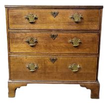 AN EARLY VICTORIAN SOLID OAK CHEST Having an arrangement of three long drawers fitted with brass