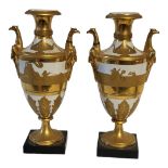 AFTER MICHEL VICTOR ACIER, A PAIR OF FRENCH EMPIRE AMPHORA SHAPED TWIN HANDLED HARD PASTE