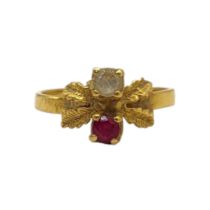 A 22CT GOLD AND RUBY RING The single round cut stone set in a textured mount. (size M) Condition: