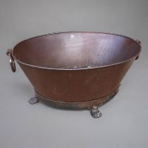 A CAST IRON OVAL WINE COOLER With ring handles on a tapering body, terminating on paw feet. (75cm