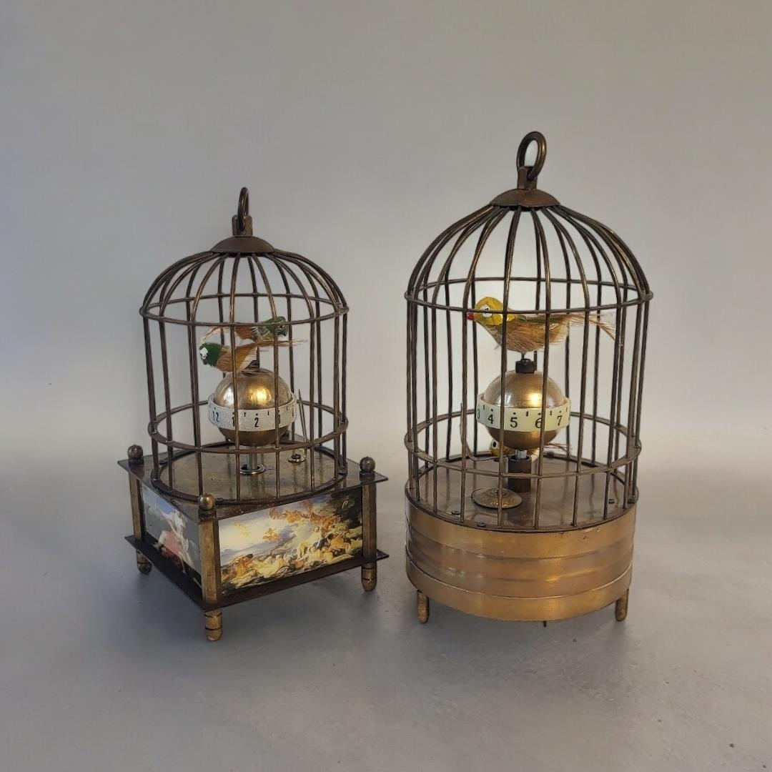 AN ORIENTAL AUTOMATED BIRDCAGE CLOCK Having two feathered birds perched on a rotating central