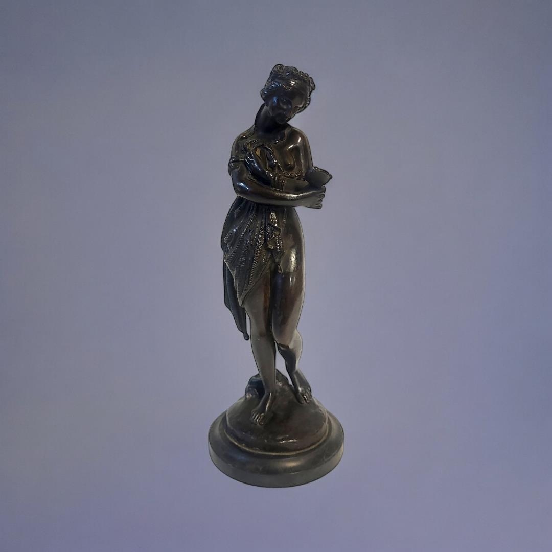 A 19TH CENTURY CONTINENTAL BRONZE FIGURE Classical form maiden with hand mirror, on black slate