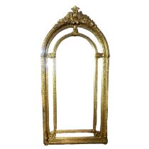 A LARGE 19TH CENTURY STYLE GILT FRAMED MIRROR Arched form crested with a floral cartouche above