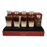CARTIER, A CASED 'LES HEURES VOYAGEUSES' FIVE PERFUME BOTTLE SET Titled 'Oud and Oud, Oud and