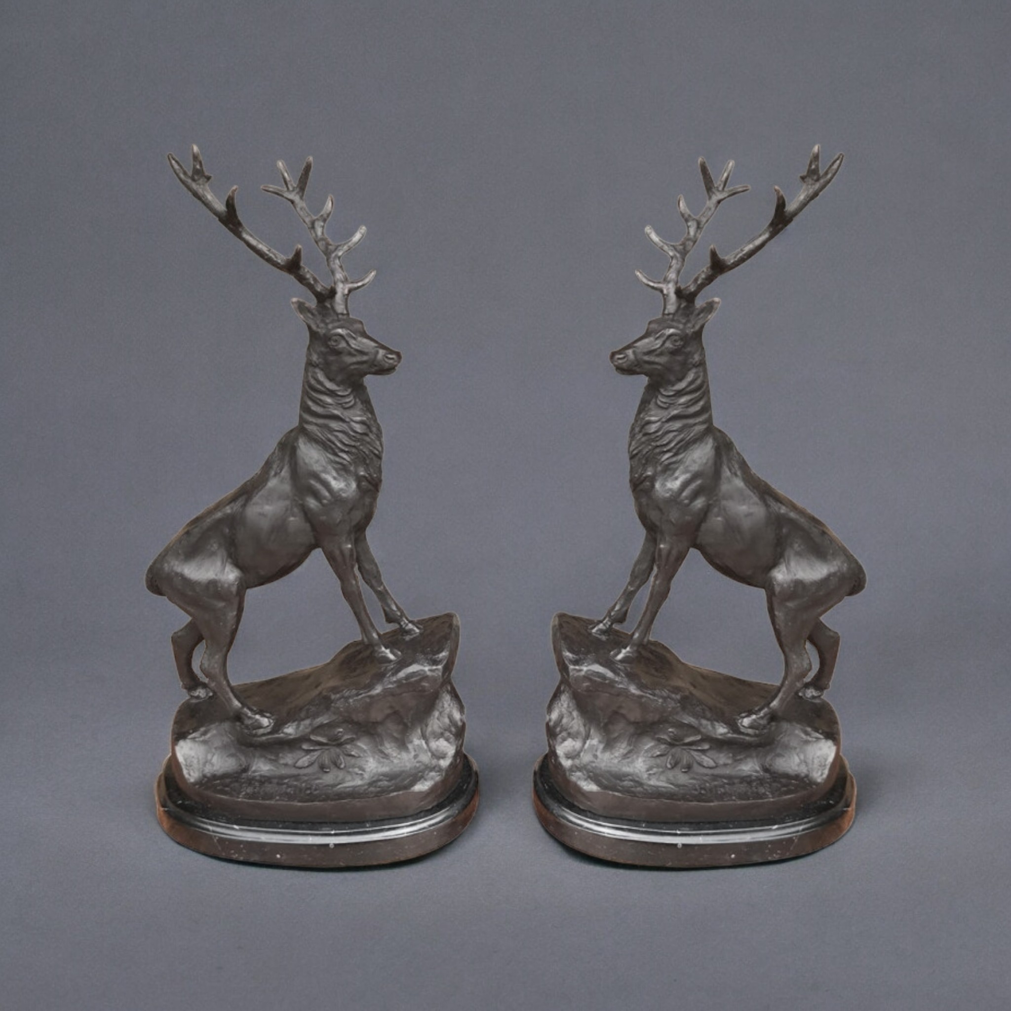 AFTER J. MOIGNIEZ, A PAIR OF LARGE BRONZE STAG STATUETTES Raised on a stone stepped pedestal base,
