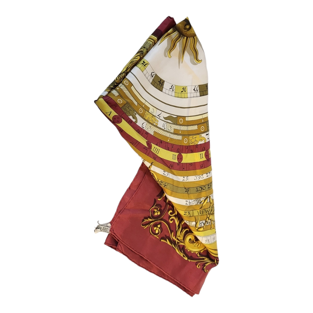 HERMES, A VINTAGE SILK 'CARRE DIES ET HORE' SCARF Signs of the zodiac within a claret border. ( - Image 2 of 3