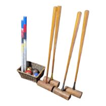 AN EARLY 20TH CENTURY WOODEN CROQUET SET, CIRCA 1900 - 1920 Consisting of four wooden long handled