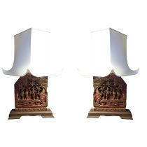 A PAIR OF CHINESE CARVED WOOD AND RED LACQUERED TABLE LAMPS With court scenes cream pagoda