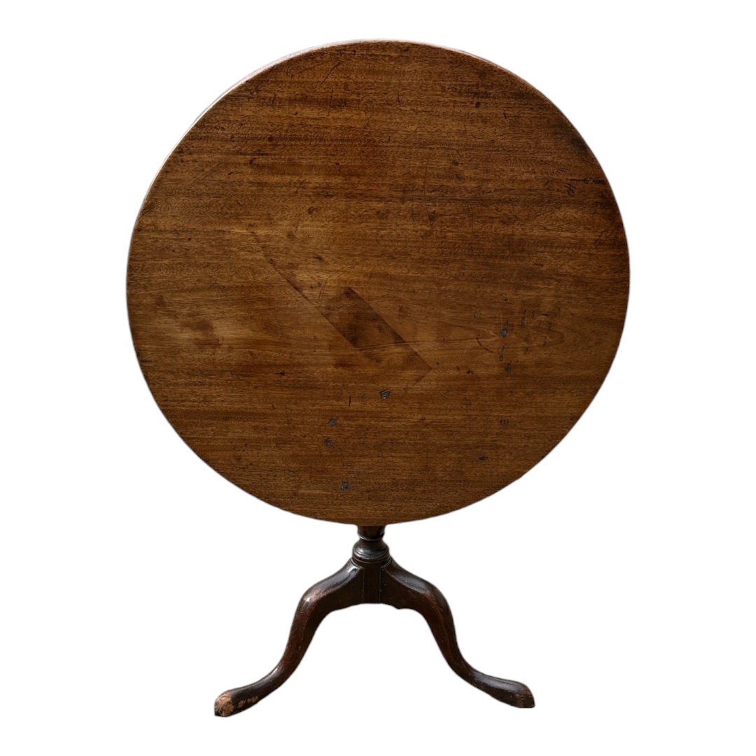 A 19TH CENTURY MAHOGANY TILT TOP SUPPER TABLE The single piece circular top on bulbous column with