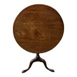 A 19TH CENTURY MAHOGANY TILT TOP SUPPER TABLE The single piece circular top on bulbous column with