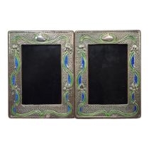 A PAIR OF ART NOUVEAU STYLE SILVER AND ENAMEL PHOTOGRAPH FRAMES Embossed floral design and wooden