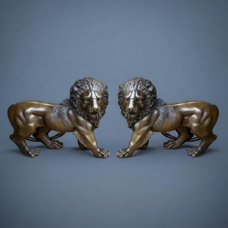 A PAIR OF JAPANESE STYLE BRONZE LIONS In the manner of the Meiji period, facing opposing directions.