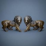 A PAIR OF JAPANESE STYLE BRONZE LIONS In the manner of the Meiji period, facing opposing directions.