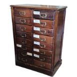 AN EARLY 20TH CENTURY STAINED PINE FLOOR STANDING COLLECTOR’S CHEST Having an arrangement of sixteen