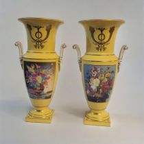 A PAIR OF YELLOW SEVRÈS STYLE CERAMIC VASES Gilt edging and panels with floral imagery on a tapering