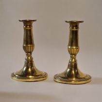 A PAIR OF EARLY 19TH CENTURY GILT BRASS CANDLESTICKS On oval bases. (approx 17cm) Condition: good
