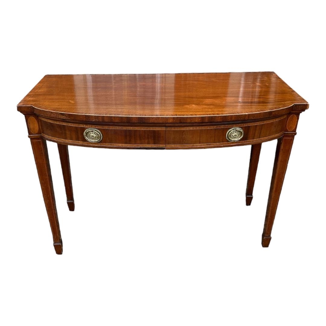 A 19TH CENTURY SHERATON DESIGN MAHOGANY AND SATINWOOD BOW FRONTED SIDE TABLE With two drawers, on