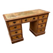 A LATE VICTORIAN BIRCH WRITING DESK With tan tooled leather surface above an arrangement of nine