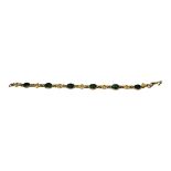 A VINTAGE CHINESE YELLOW METAL AND JADE BRACELET Cabochon cut stones in a pierced design. (approx