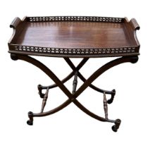 A GEORGIAN STYLE MAHOGANY TRAY TOP COACHING TABLE With pierced fretwork gallery on folding stand. (