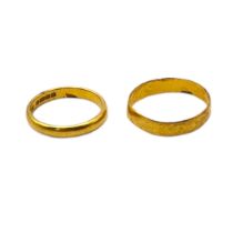 TWO EARLY 20TH CENTURY 22CT GOLD WEDDING BANDS. (size M) Condition: slight dents to one ring