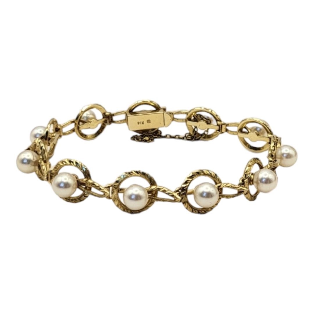 MIKIMOTO, A VINTAGE 14CT GOLD AND PEAL BRACELET Having a single row of pearls within a pierced - Image 7 of 7