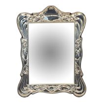 A 20TH CENTURY SILVER EASEL MIRROR Having embossed scrolled frame, hallmarked Birmingham, 1988, in