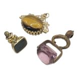 A VINTAGE 9CT GOLD AND HARDSTONE SWIVEL FOB Set with oval tiger's eye and onyx stones, together with