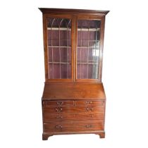 A MID CENTURY GEORGIAN STYLE MAHOGANY BUREAU BOOKCASE The cornice above two gothic pointed arch