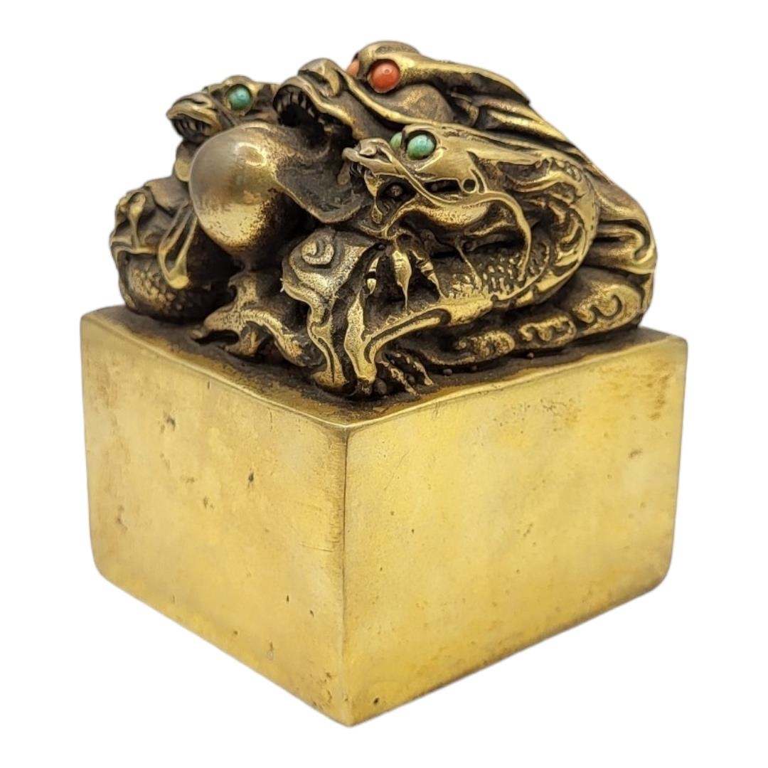 A CHINESE BRONZE DRAGON SEAL The eyes inset with coloured stones on a patinated body, with inscribed - Image 2 of 4