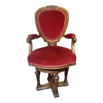 A VICTORIAN WALNUT CAPTAINS CHAIR With bow shield back, open arms and overstuffed upholstered seat