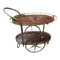 A VINTAGE BRASS AND MAHOGANY TWO TIER TRAY TOP DRINKS TROLLEY With pierced galleries, spindled