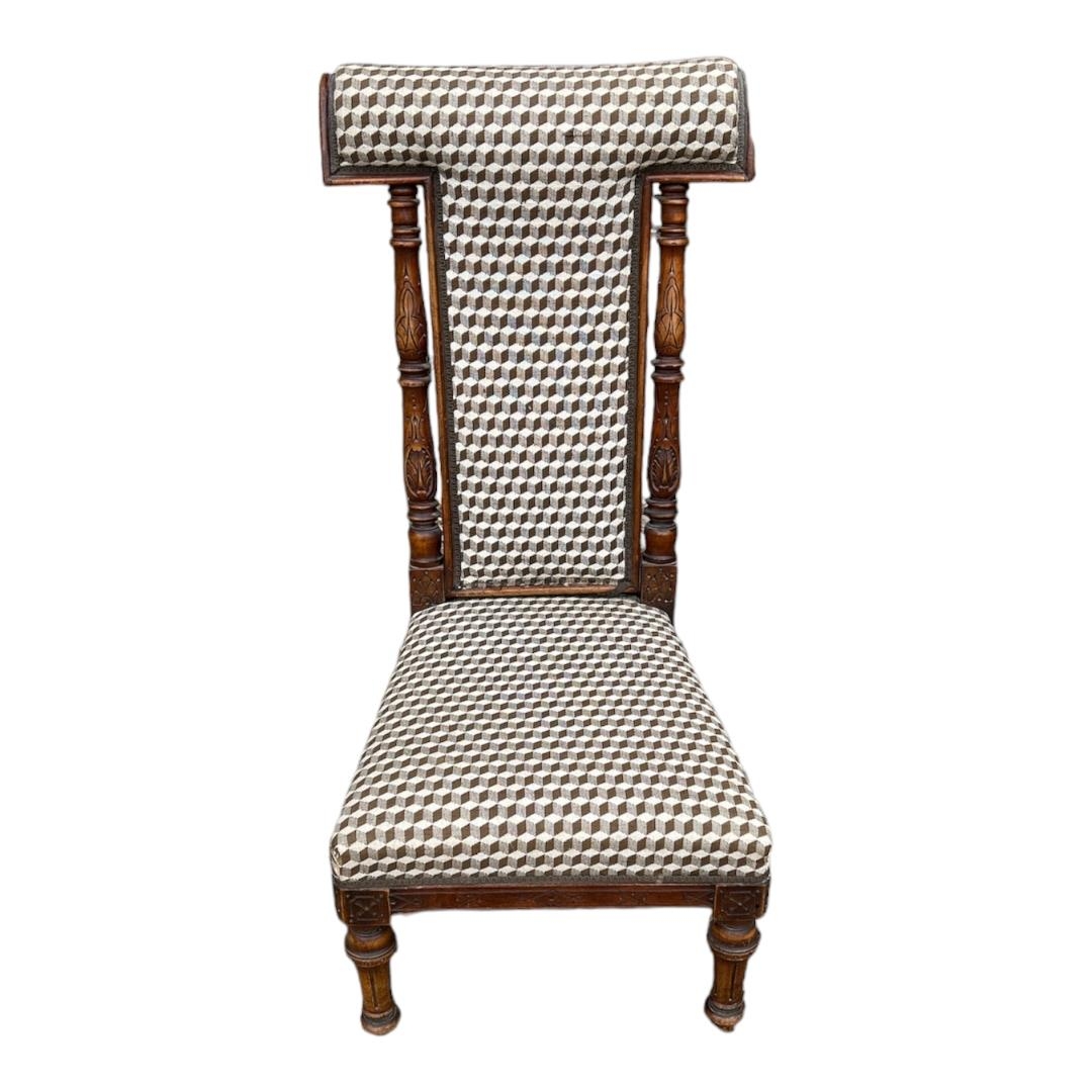 A LATE VICTORIAN BEECHWOOD PRAYER CHAIR In later fabric upholstery, on turned legs terminating on