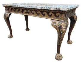 MANNER OF WILLIAM KENT, AN 18TH CENTURY CARVED WALNUT AND PARCEL GILT CENTRE TABLE The coloured