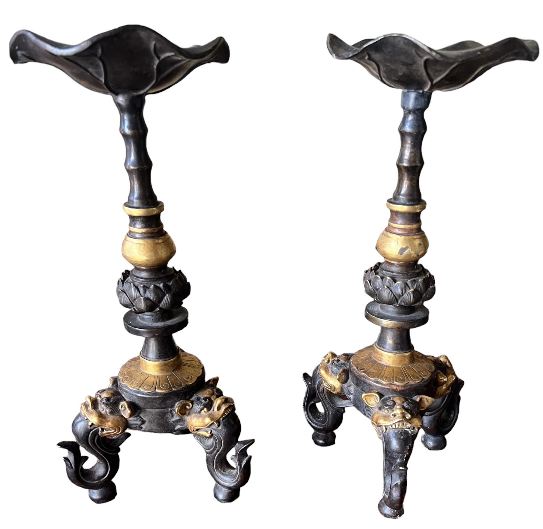 A PAIR OF CHINESE GILT BRONZE TABLE PRICKET STANDS The columns decorated with Lotus Leaf above three