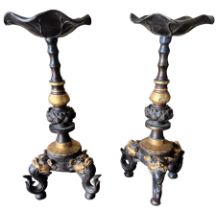 A PAIR OF CHINESE GILT BRONZE TABLE PRICKET STANDS The columns decorated with Lotus Leaf above three