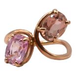 A VINTAGE ROSE METAL, PINK SAPPHIRE AND PINK TOURMALINE STYLISED CROSSOVER RING, ROSE METAL TESTED
