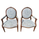 A PAIR OF 19TH CENTURY FRENCH LOUIS XVI DESIGN OPEN ARMCHAIRS The back carved with ribbons above