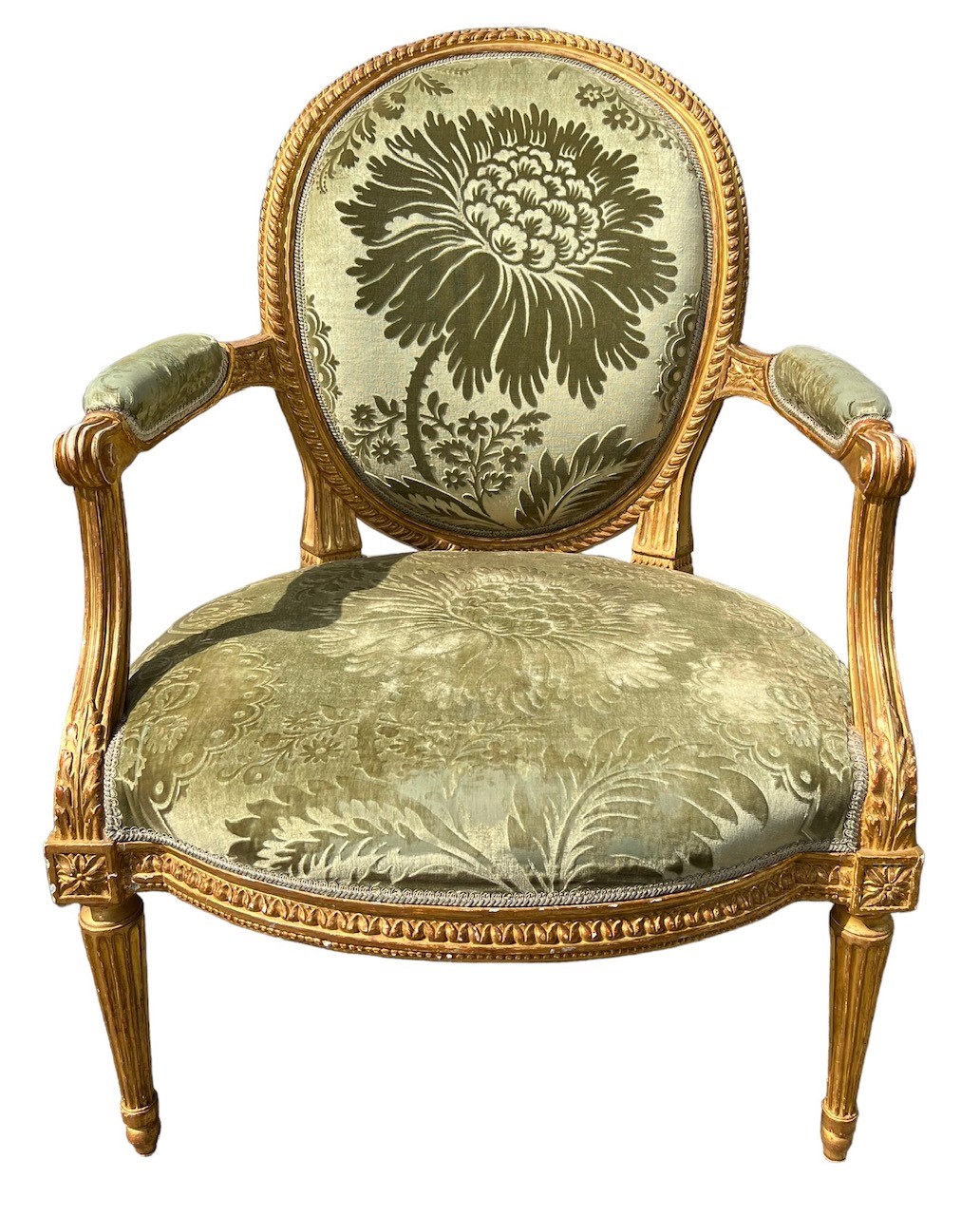 LOUIS DELANOIS, AN 18TH CENTURY FRENCH LOUIS XVI CARVED GILTWOOD ARMCHAIR With oval padded back,