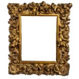 AN 18TH CENTURY ITALIAN FLORENTINE CARVED GILTWOOD MIRROR Decorated with scrolling foliage and