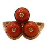 A POLISH 14CT GOLD AND THREE STONE CORAL RING Having three circular cabochon cut corals (approx