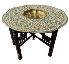 A LARGE DECORATIVE EARLY 20TH CENTURY INDIAN BRASS TRAY TOP TABLE The shaped circular top with
