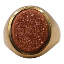 A 9CT GOLD AND RED GOLDSTONE GENTS SIGNET RING Having unengraved flat oval cut red goldstone,