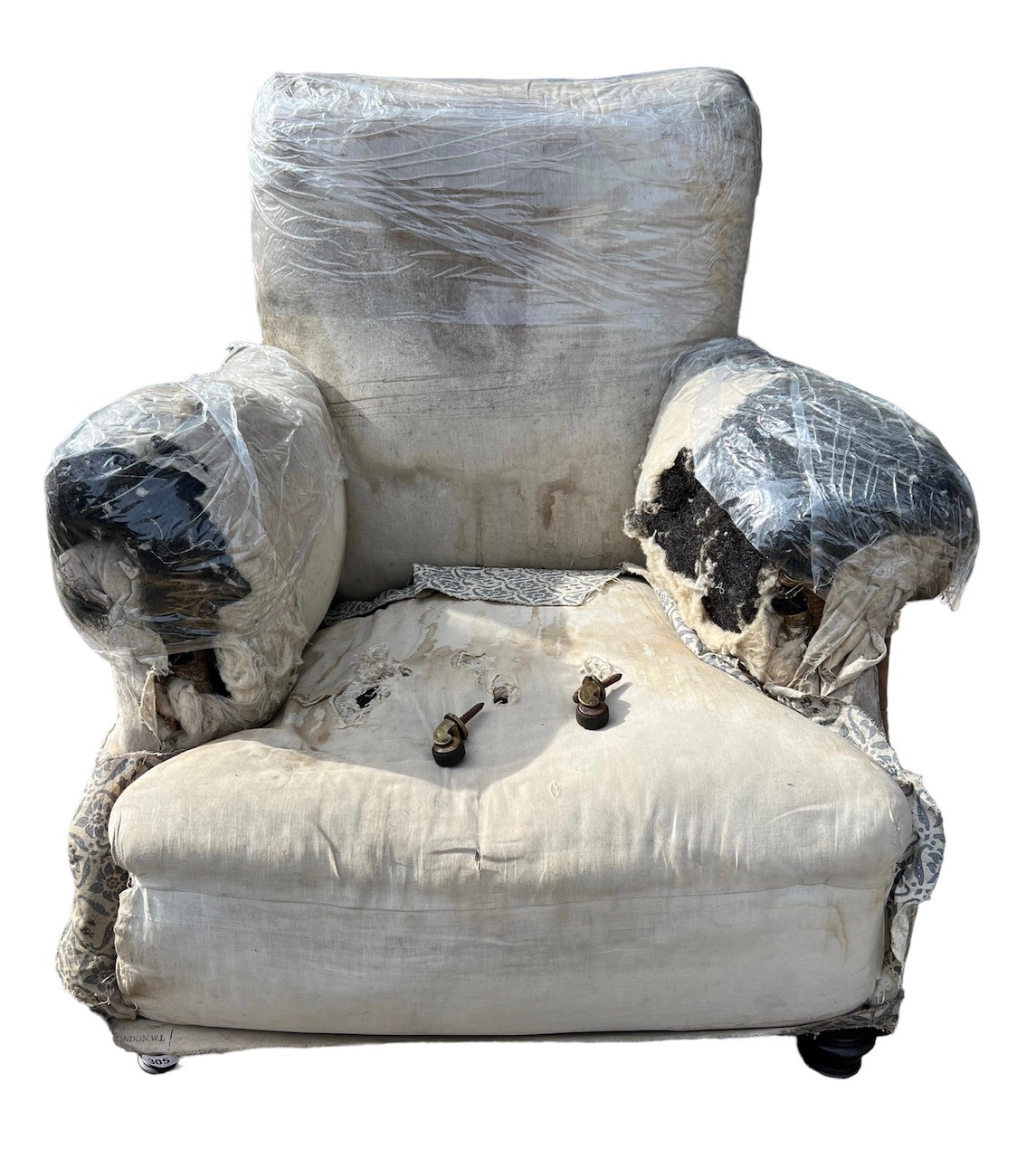 HOWARD AND SONS, A LATE 19TH CENTURY EASY ARMCHAIR With remnants of original upholstery, raised