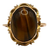 A POLISH 14CT GOLD AND TIGER’S EYE COCKTAIL RING Having a central oval cabochon cut tiger's eye (