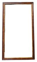 AN 18TH CENTURY WALNUT AND PARCEL GILT PIER MIRROR. (77cm x 42.5cm)